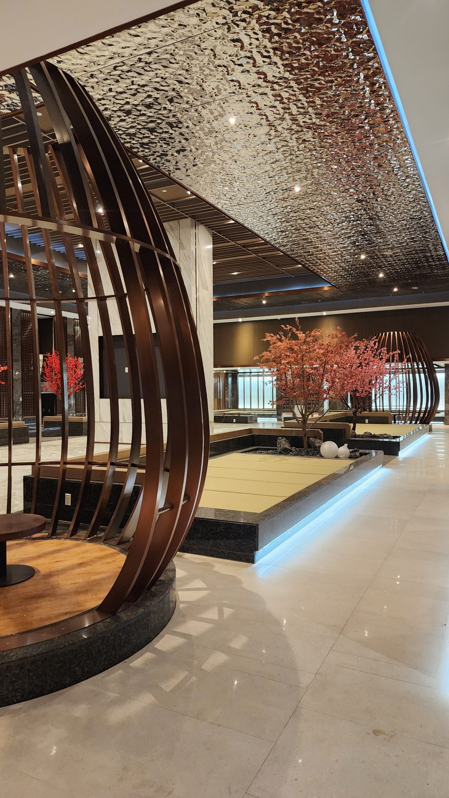 Interior of a wellness center with waiting benches and lantern-style decorations.